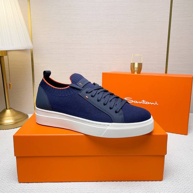 Santoni 圣东尼 这是一款男士低帮运动鞋，由意大利制造。 材质与构造：采用进口飞织拼接皮制作，未加内衬且解 构设计，呈现简约风格。 颜色与细节：鞋身为黑色