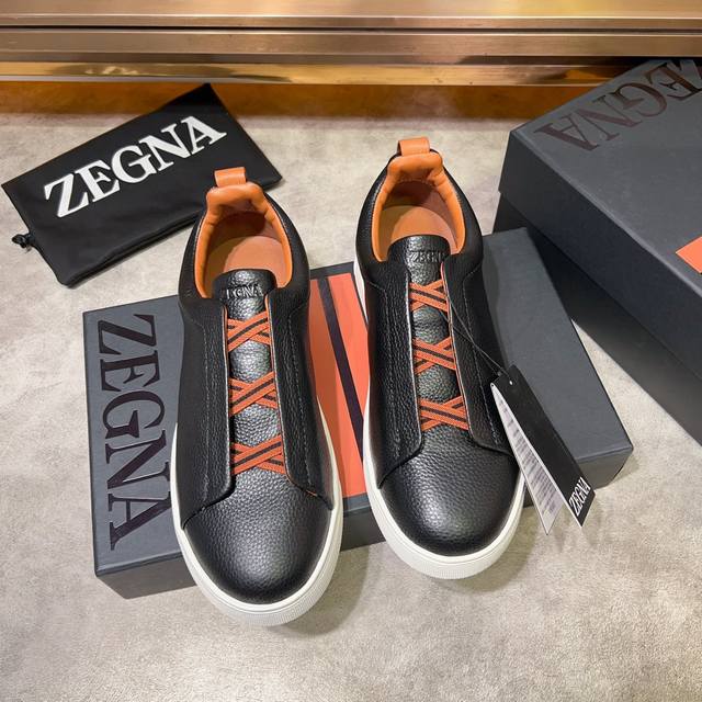 Ermenegildo Zegna 杰尼亚 光滑皮革 Tiziano 低帮运动鞋 这款tiziano 低帮运动鞋摔花纹牛皮制成，饰以丰富的工艺细节，如骆马红棕色