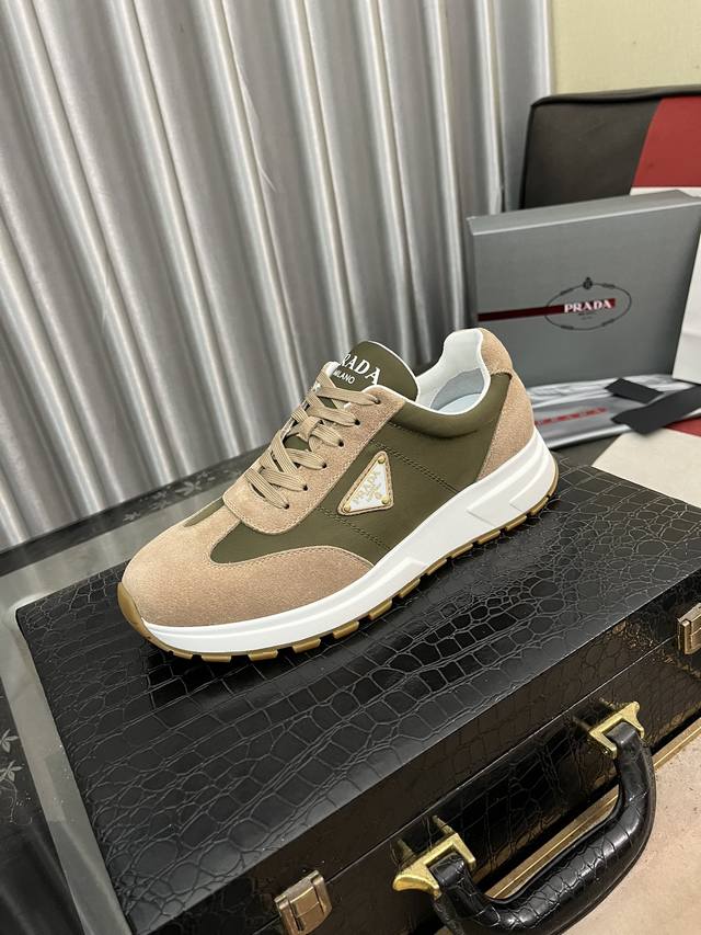 出厂价： Prada 普拉达新款男士厚底休闲运动鞋，运动鞋低帮系带款 款式时尚大方 头层牛皮拼接透气网面打造 柔软舒适透气 鞋舌字母logo标 细节精工细作 轻